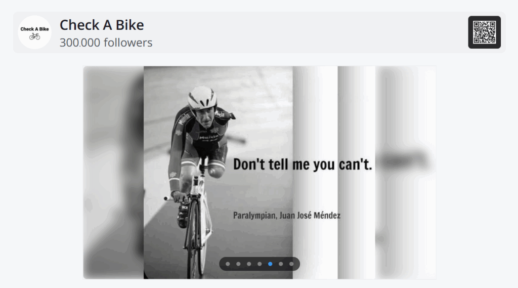 Facebook post displayed through the platform's digital signage showing an inspirational quote by Paralympian Juan José Méndez over a black-and-white cycling image, with profile name "Check A Bike" and follower count.